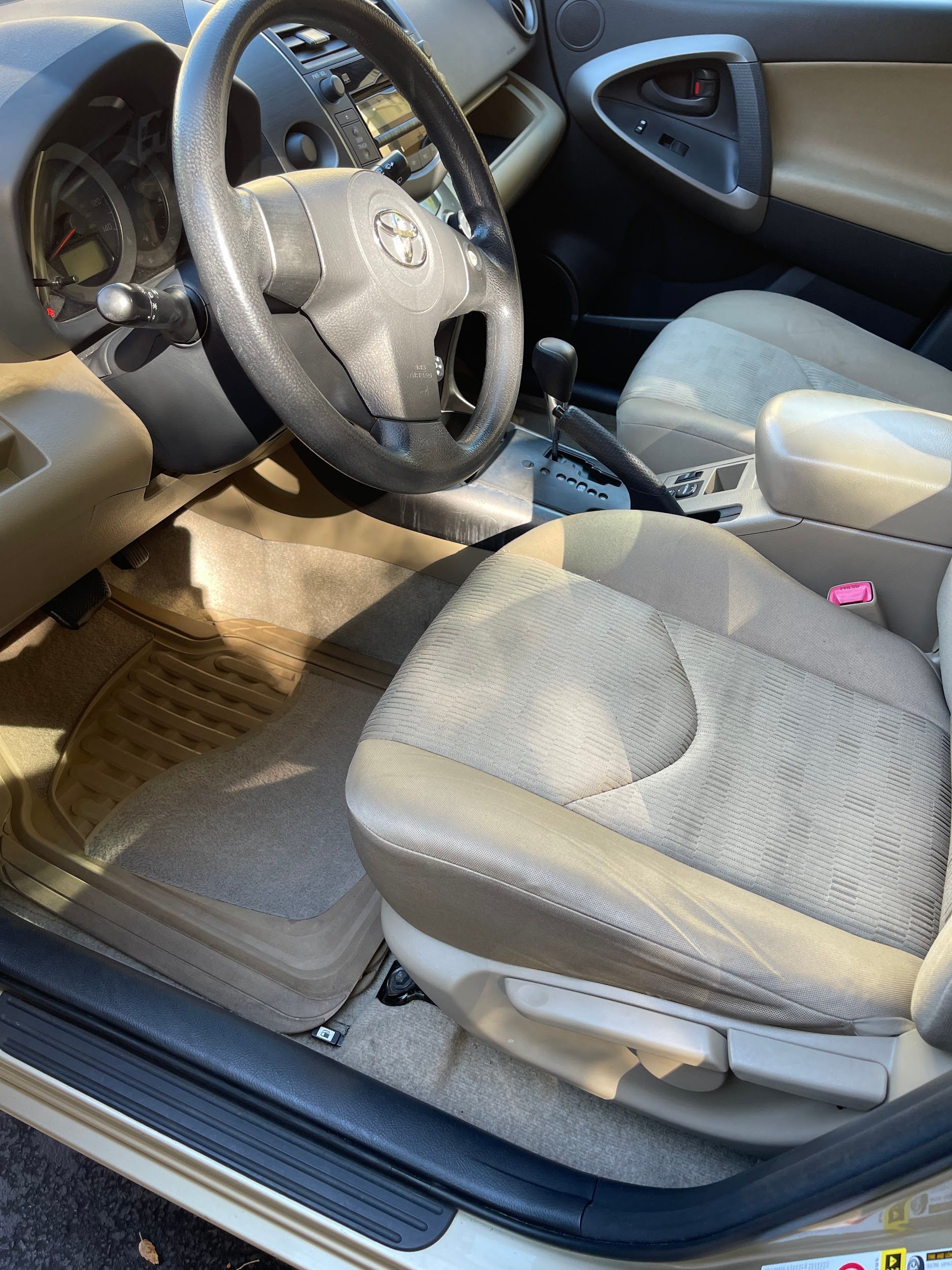 The inside of a car with a steering wheel and seats