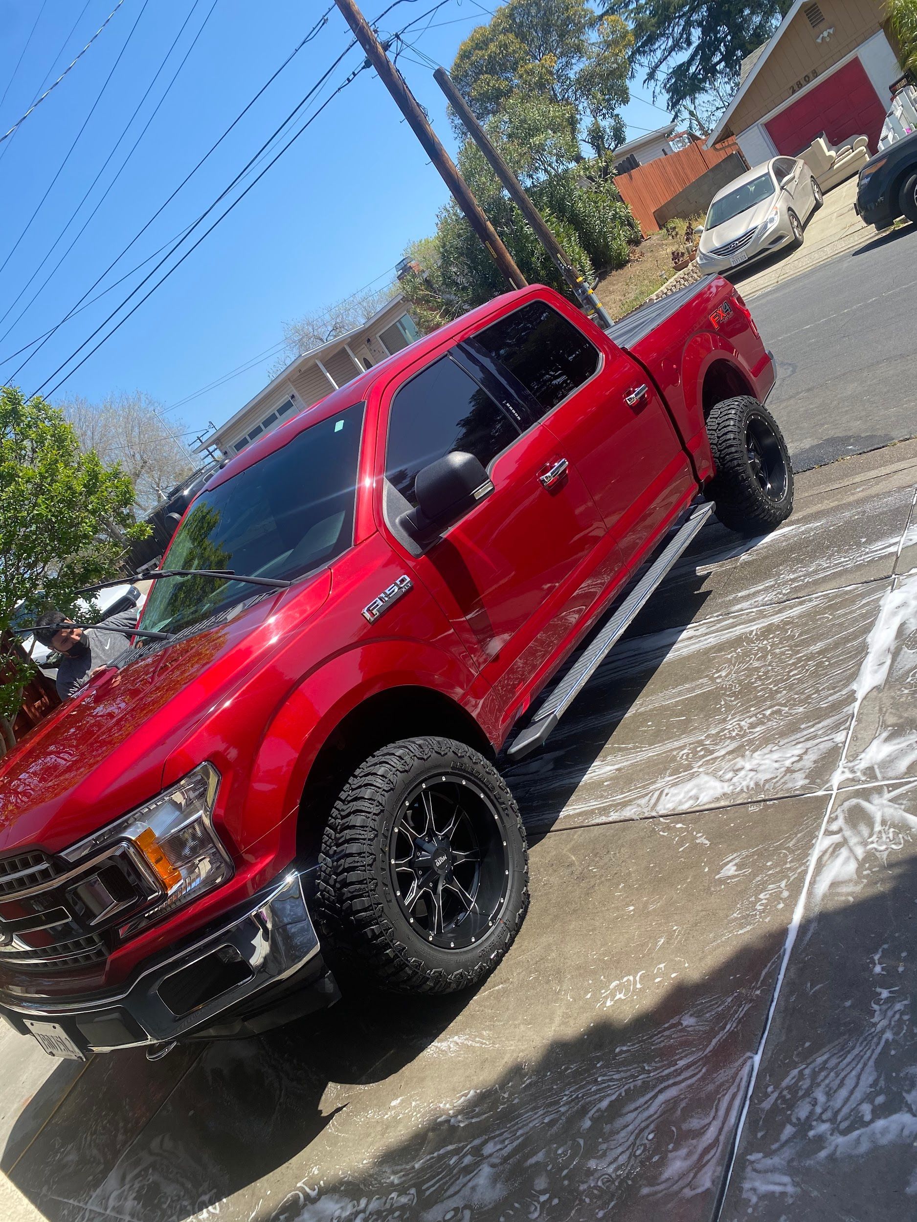 A red truck is parked on the side of the road.