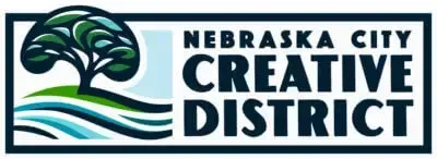 The logo for the nebraska city creative district shows a tree and a river.