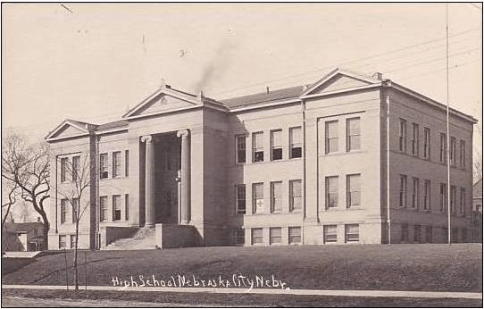 A black and white photo of a large building that says high school