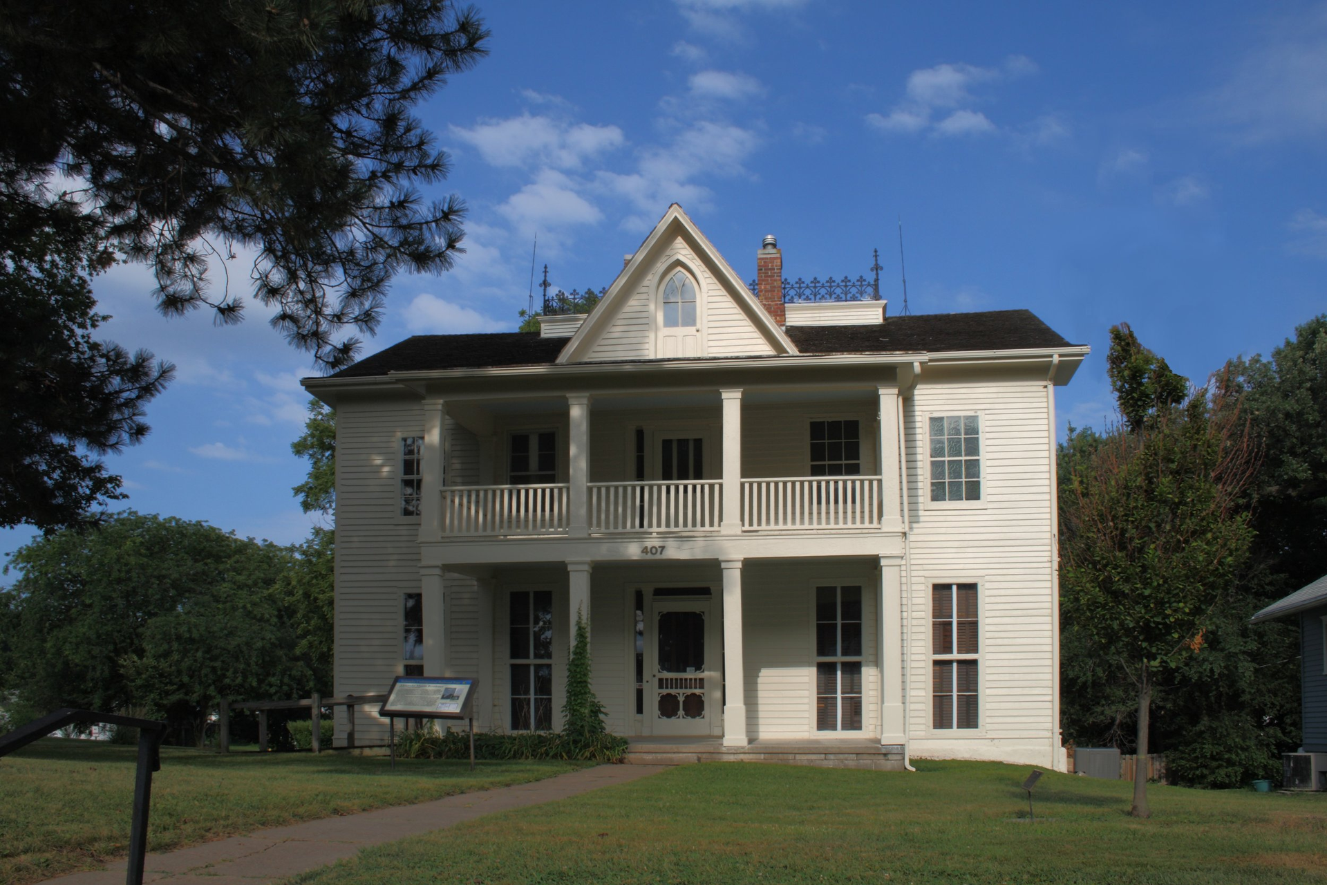 A large white house with a large porch