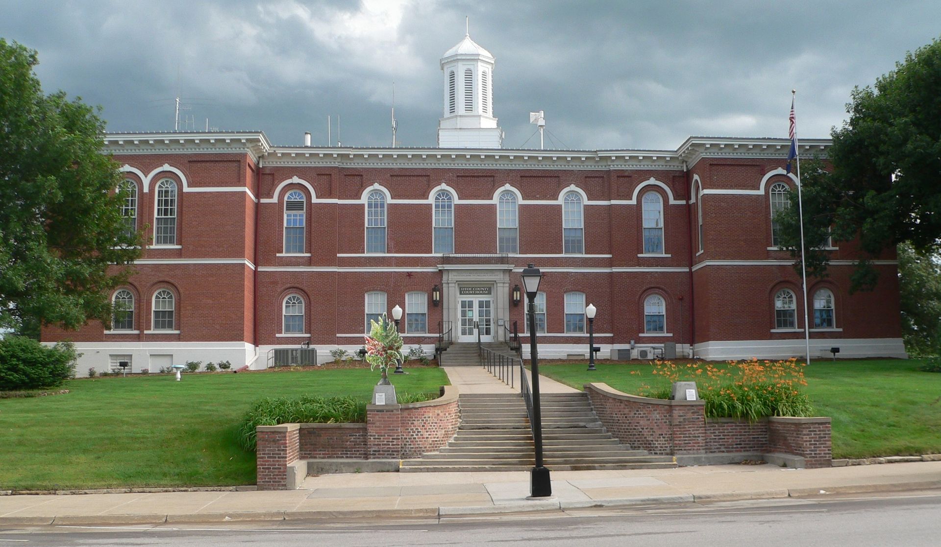 A large brick building with a white tower on top