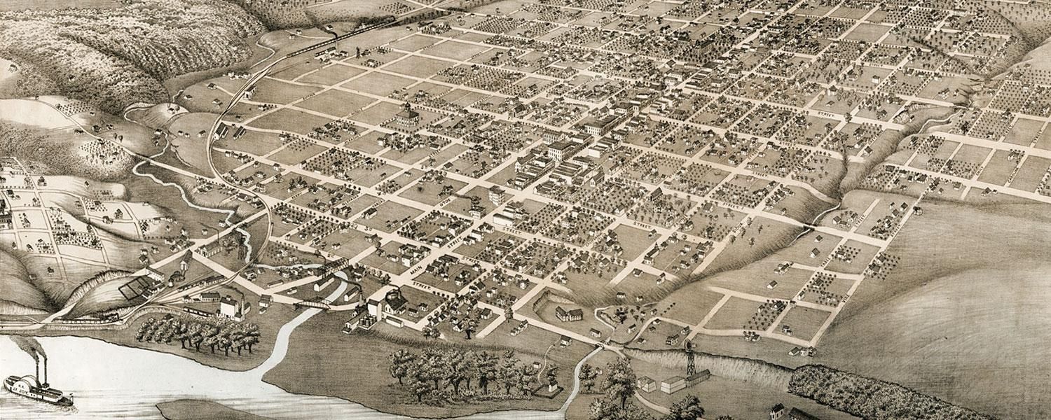 A black and white aerial view of a city with a river running through it.