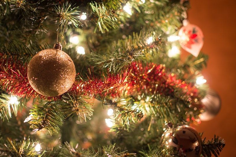 A close up of a christmas tree with decorations and lights.