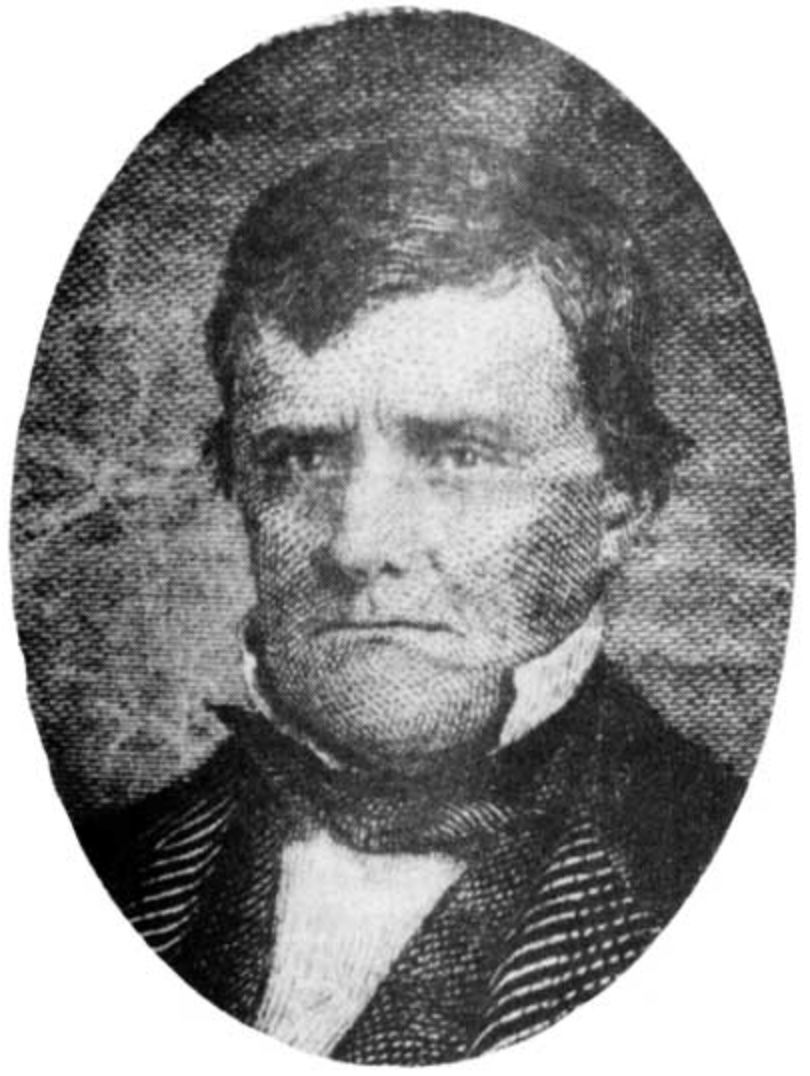 A black and white photo of a man in a tuxedo