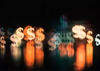 Blurred dollar signs against a dark background, with orange and white highlights.
