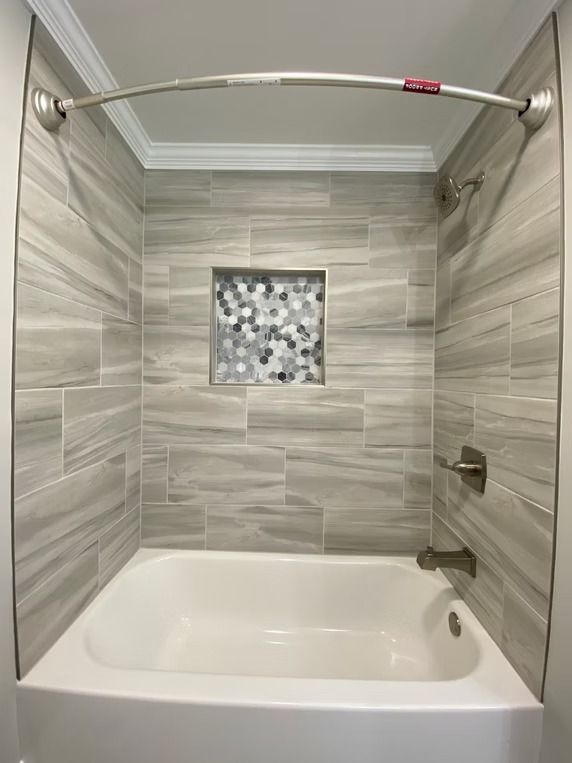 A bathroom with a bathtub and a shower.
