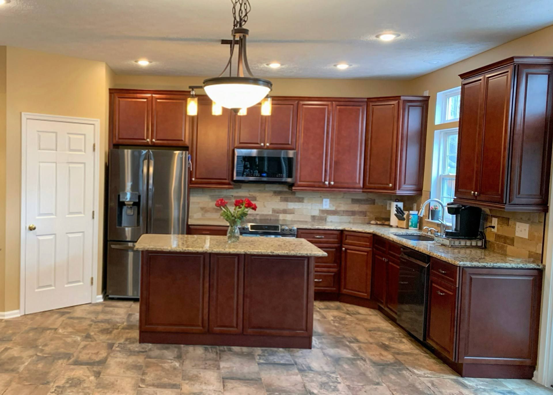 A kitchen with stainless steel appliances and wooden cabinets