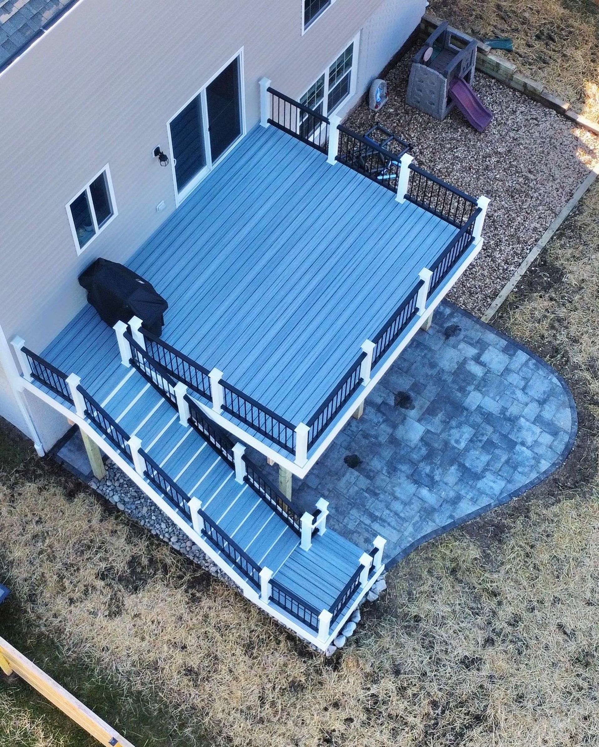 An aerial view of a house with a blue deck