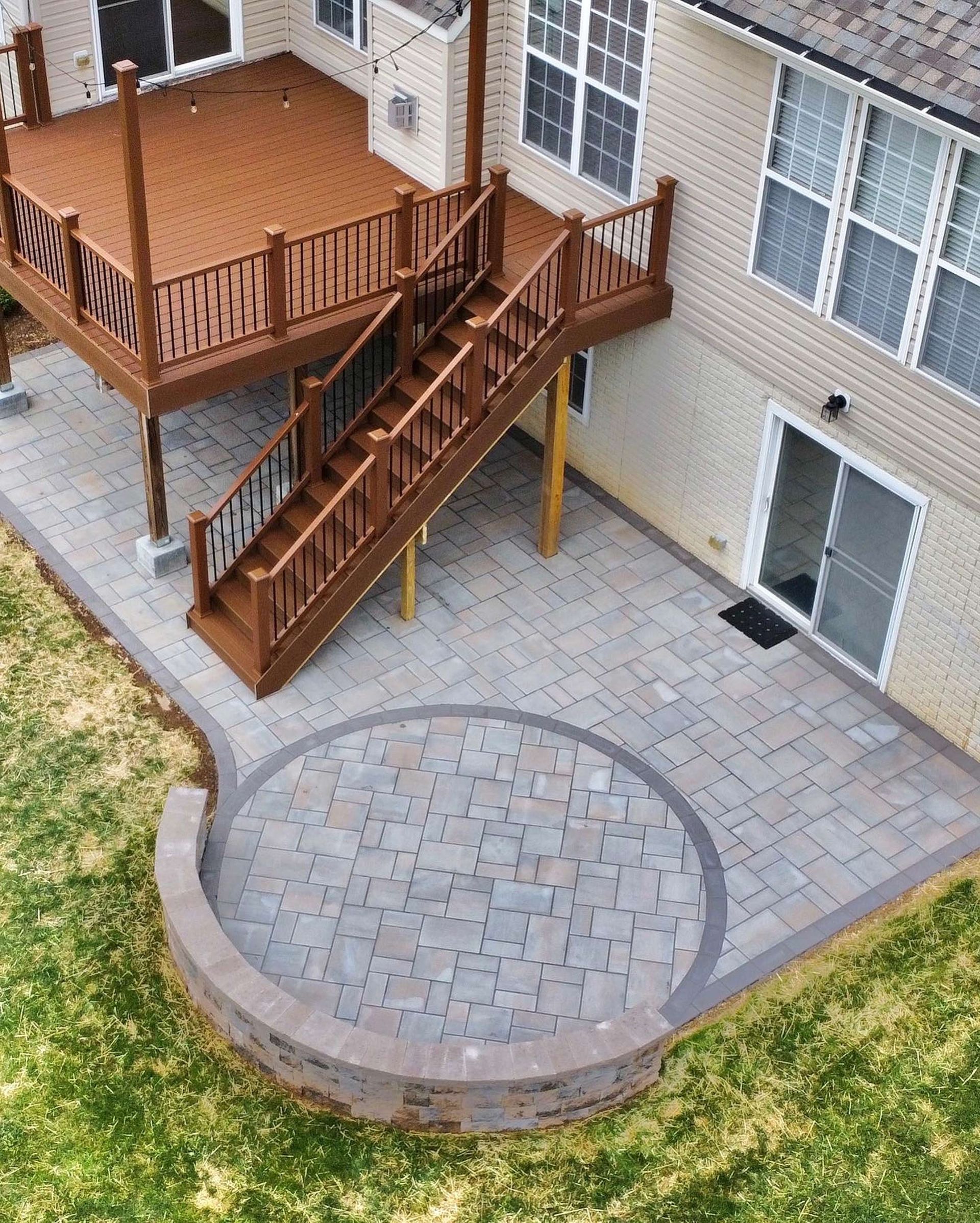 An aerial view of a house with a large deck and patio.