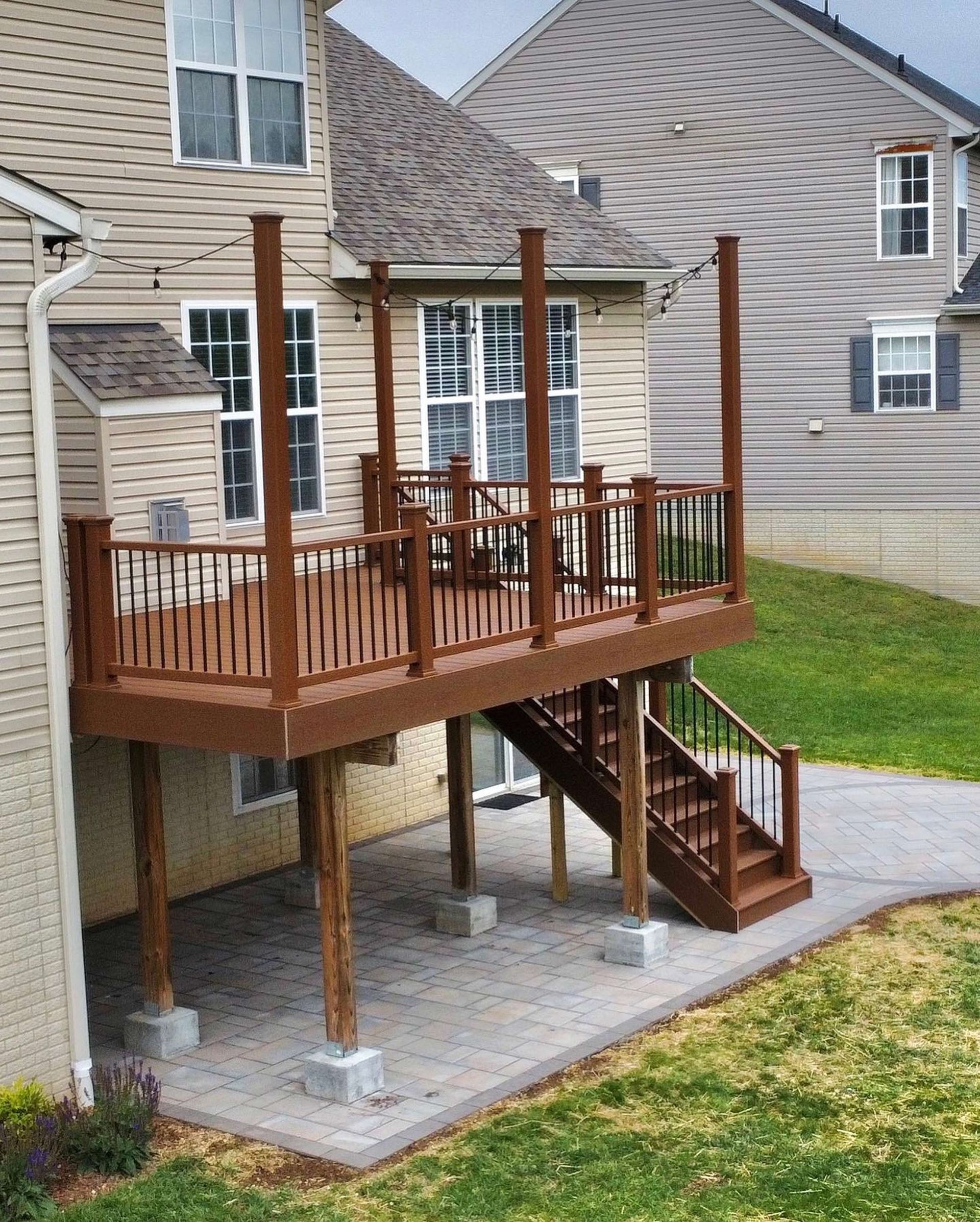 A house with a deck and stairs in front of it