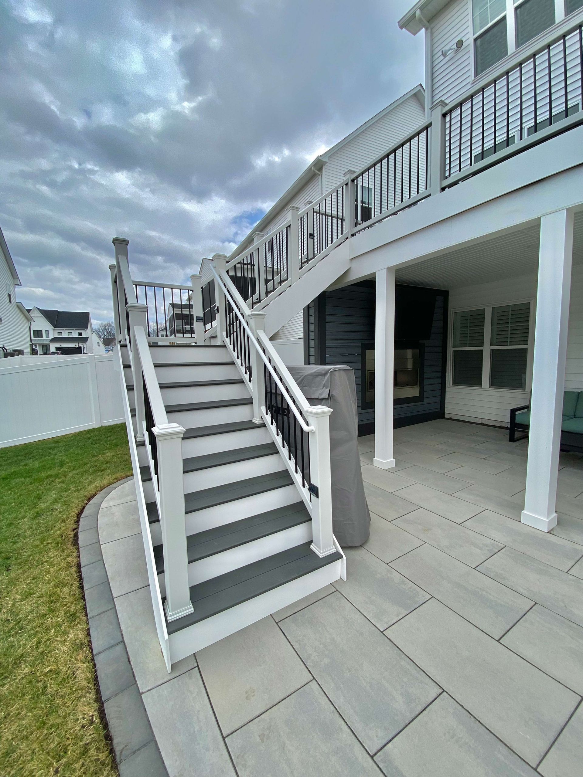 There are stairs leading up to the deck of a house.