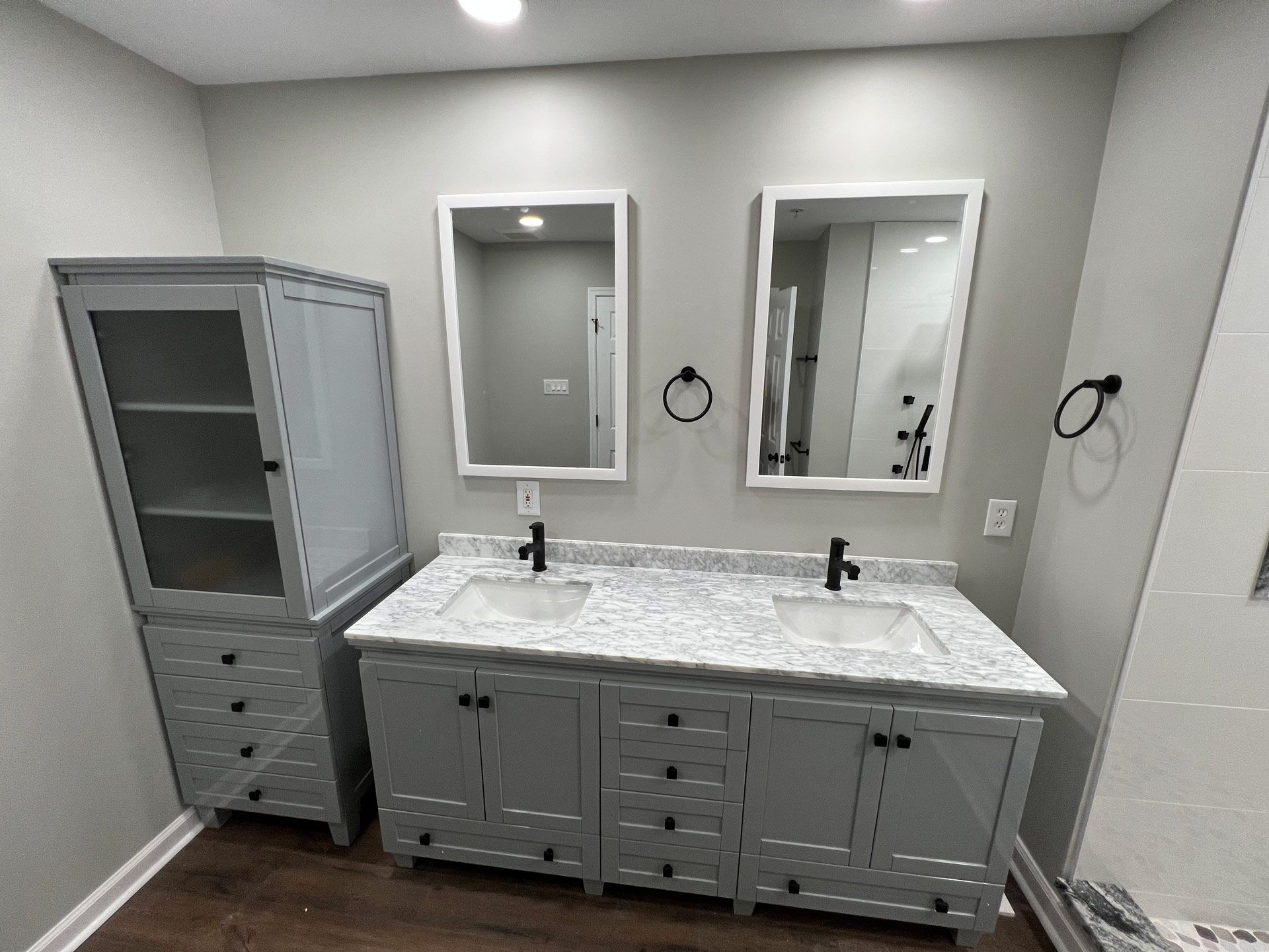 A bathroom with two sinks and two mirrors.