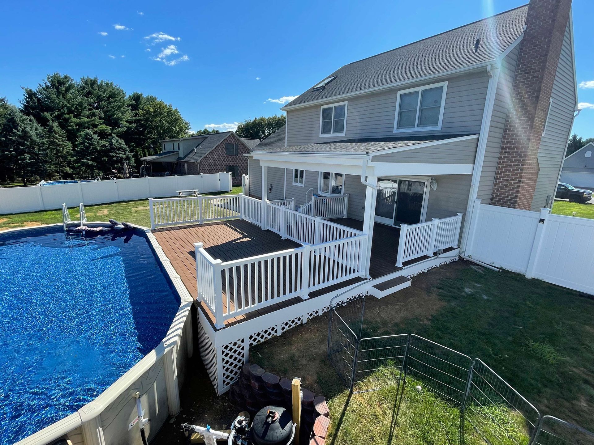 A house with a large deck and a pool in the backyard.