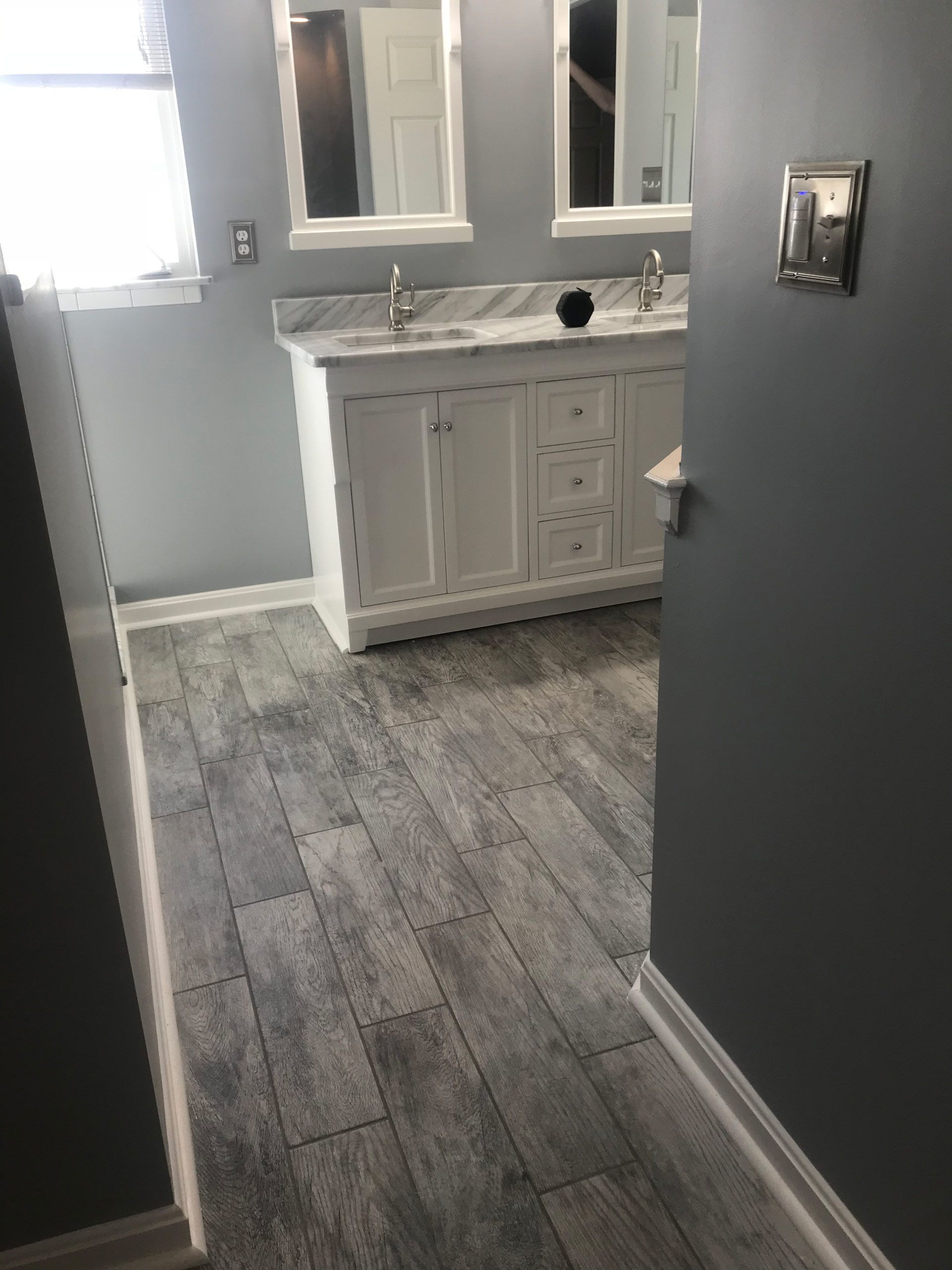 A bathroom with two sinks and two mirrors.