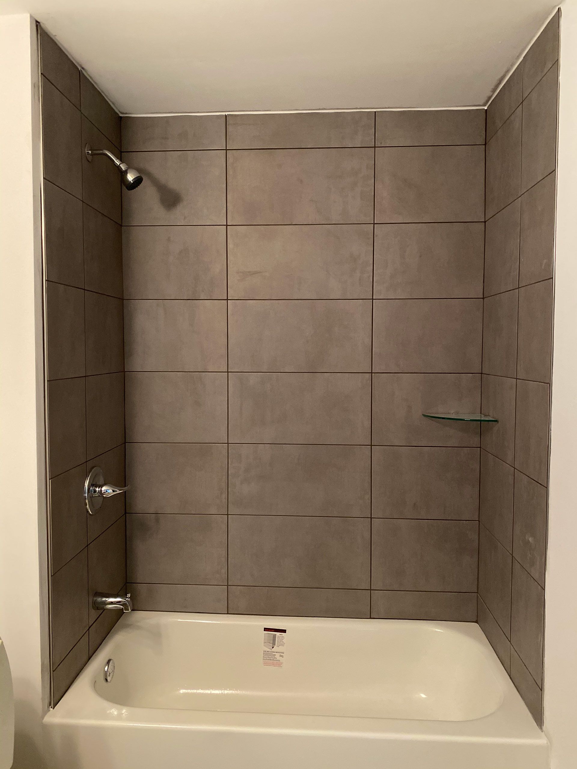 A bathroom with a bathtub and a shower.