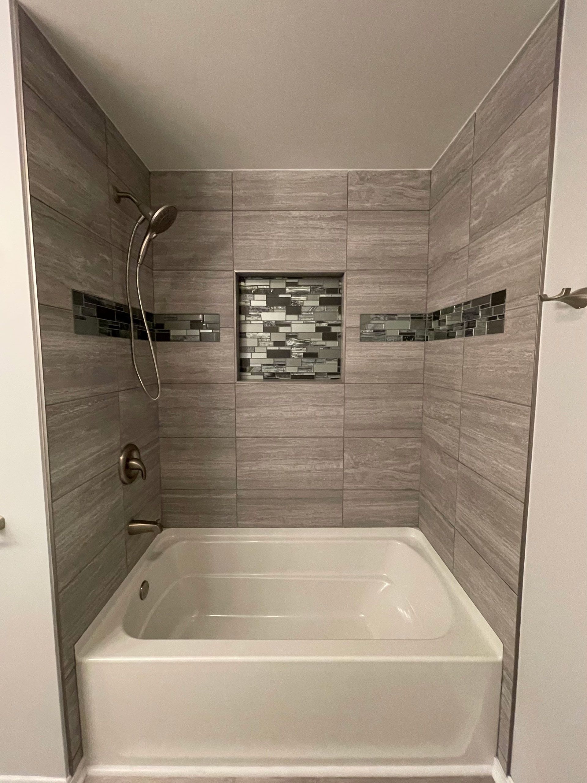 A bathroom with a bathtub and a shower.