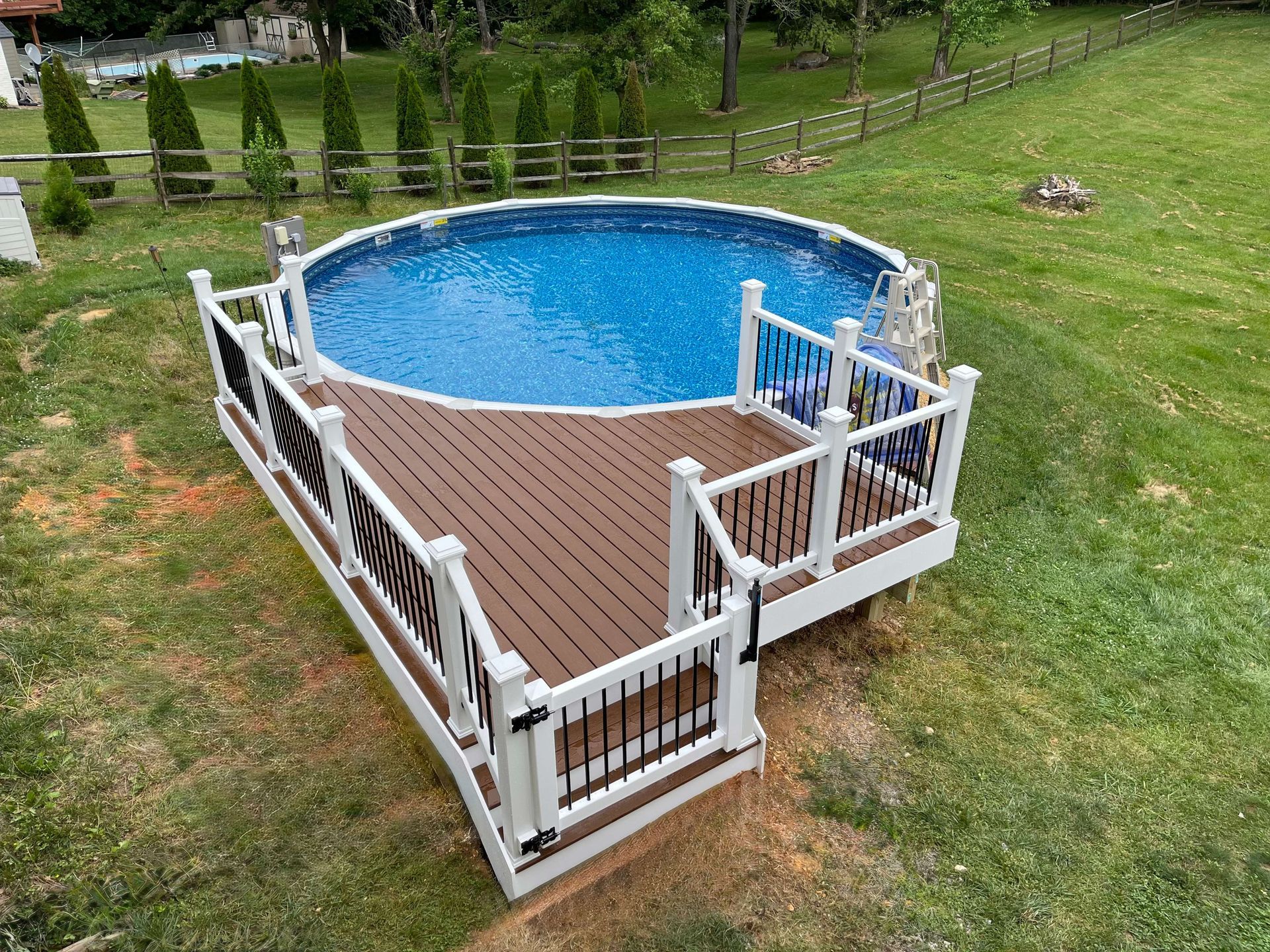 There is a swimming pool with a deck around it.