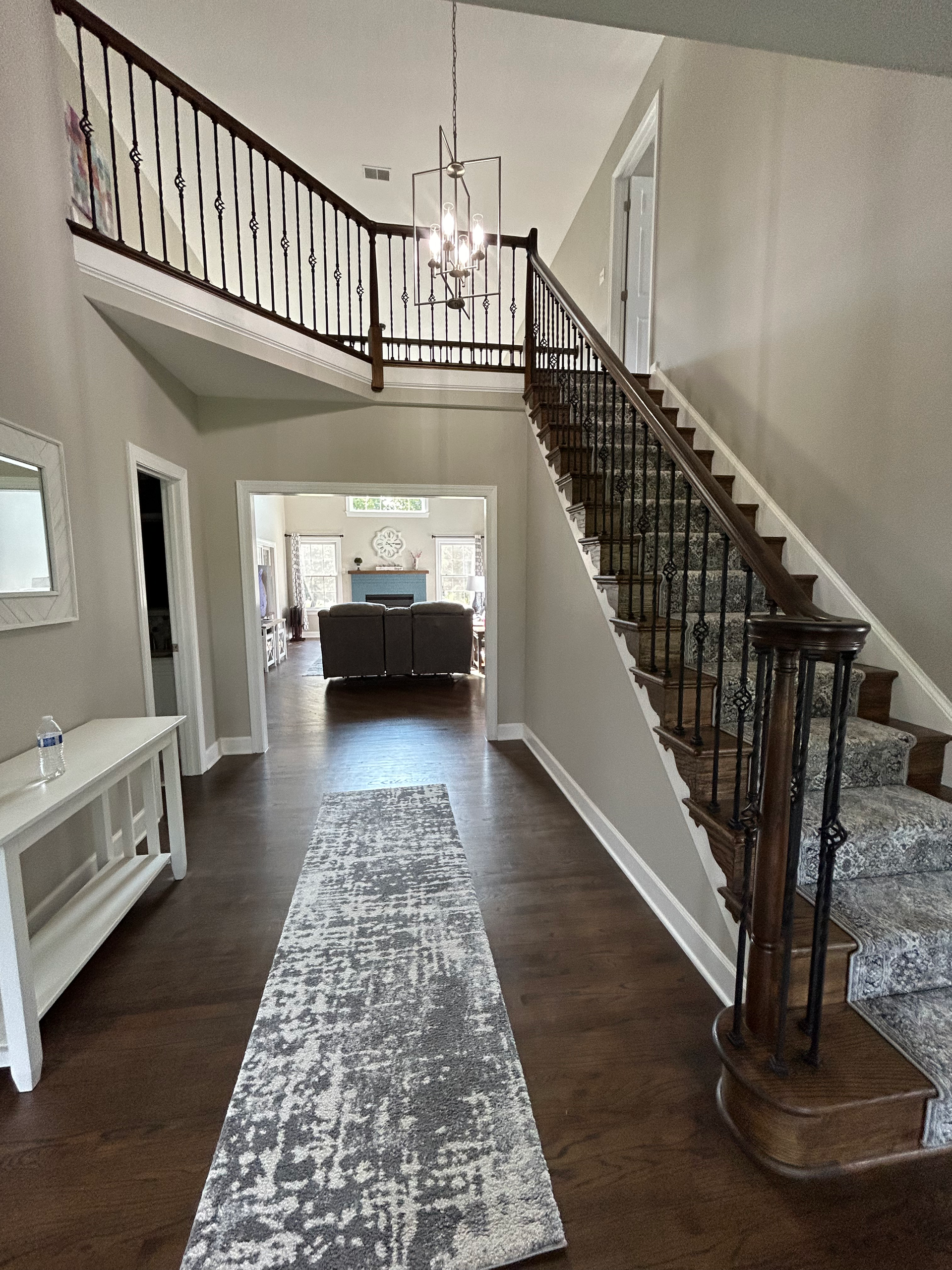 A hallway with stairs leading up to the second floor of a house