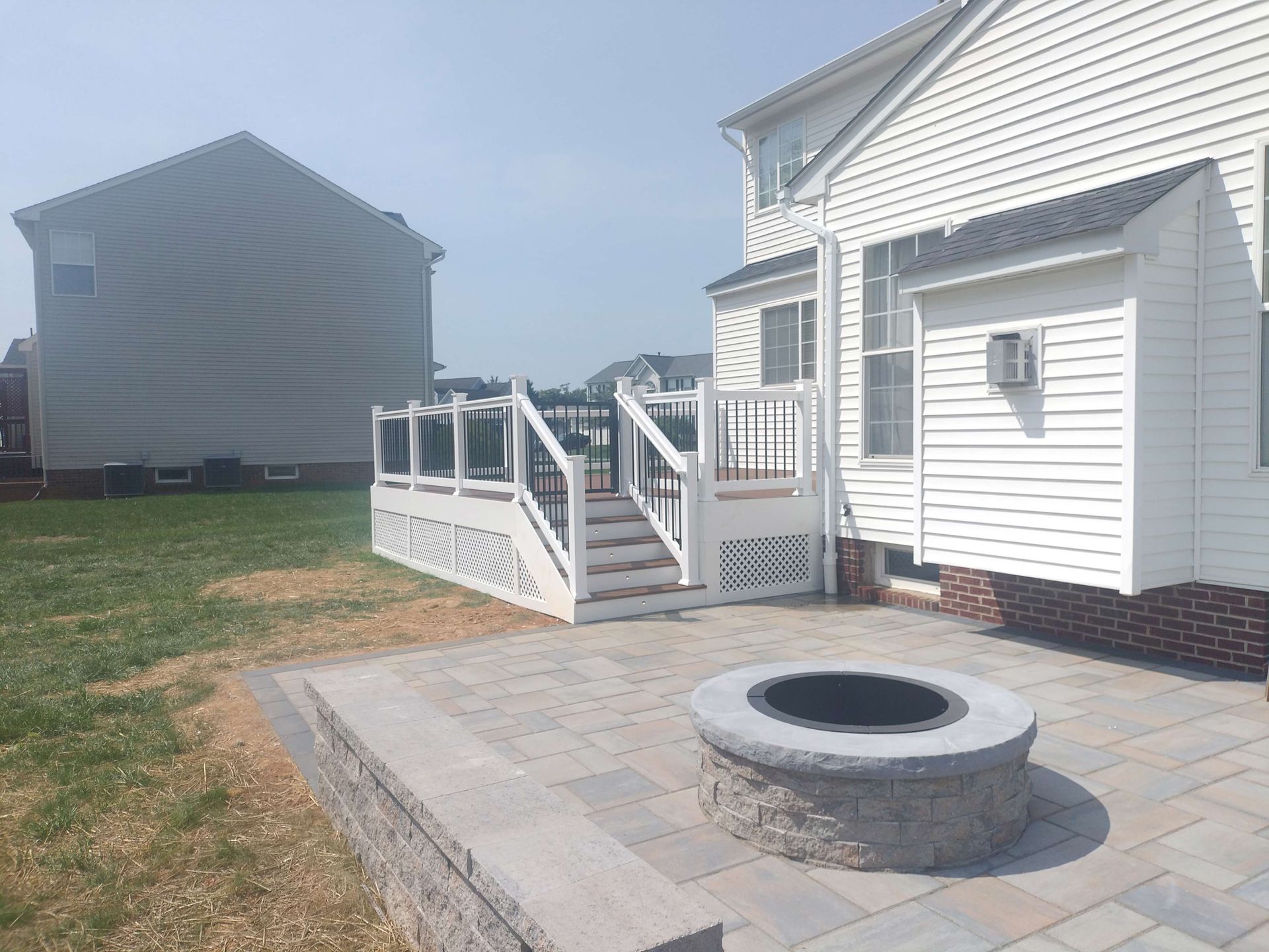 There is a fire pit in the backyard of a house.