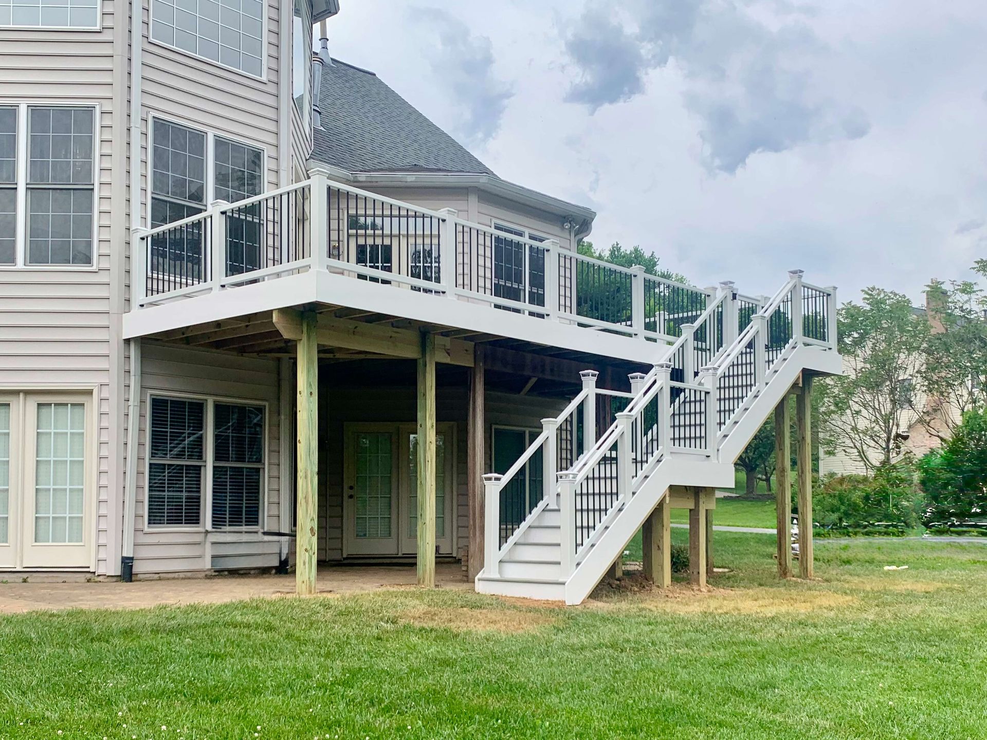 There is a large deck with stairs leading up to it.