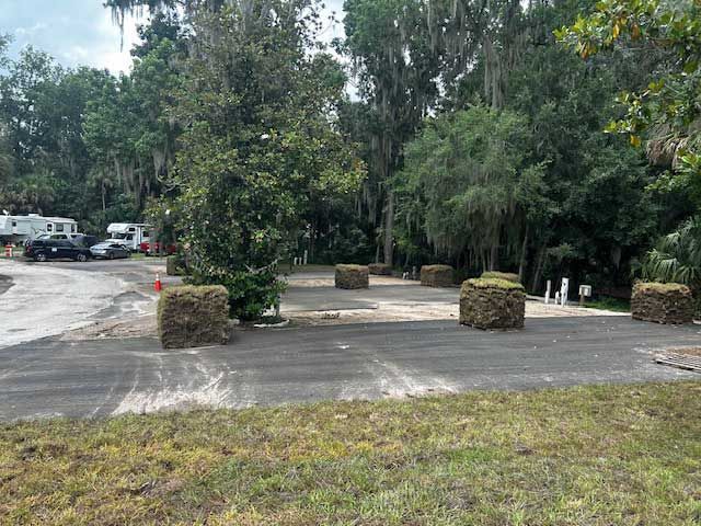 A white fence along the side of a road
