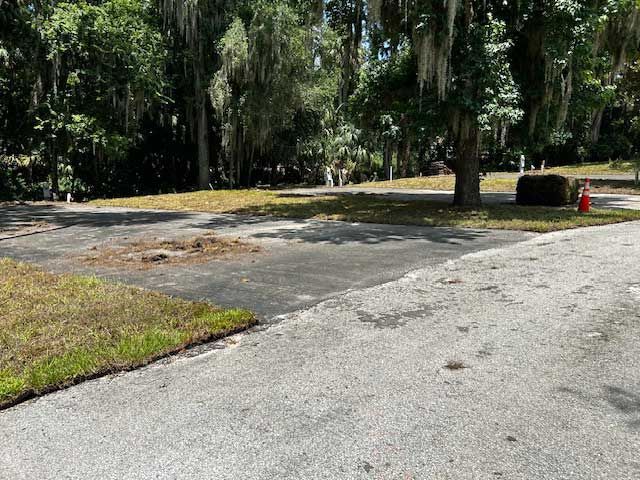 A cracked asphalt road with a white line on it