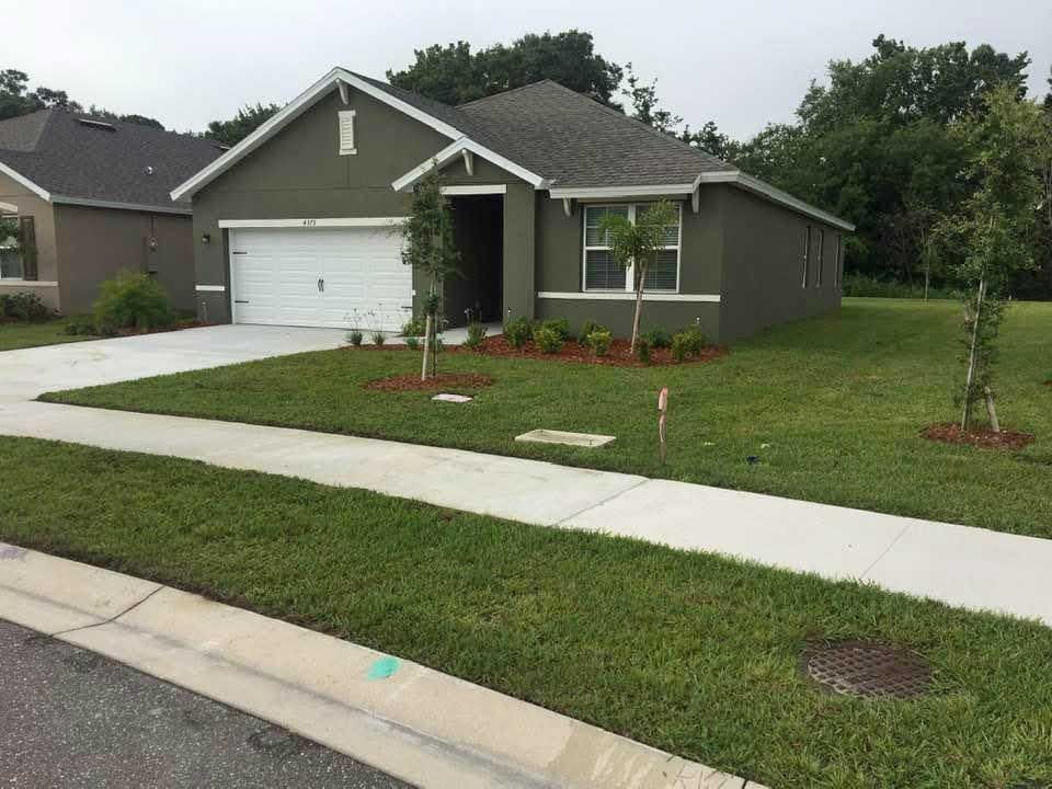 A house with a white garage door is in a residential area