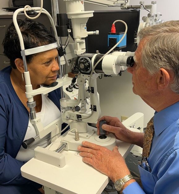 Male Optician With A Senior Patient To Measure Visual Eyesight — Montgomery, AL — Coates Optical Clinic