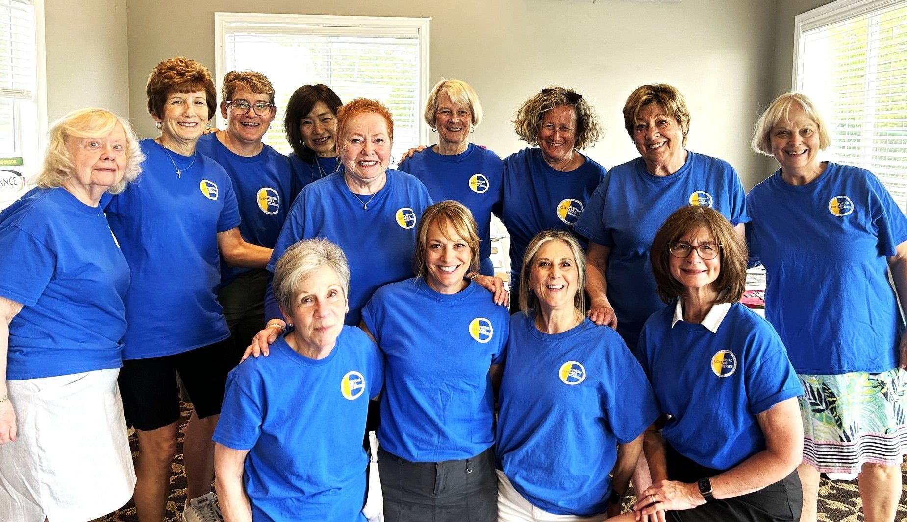 Hands holding a small pile of coins against a turquoise background.