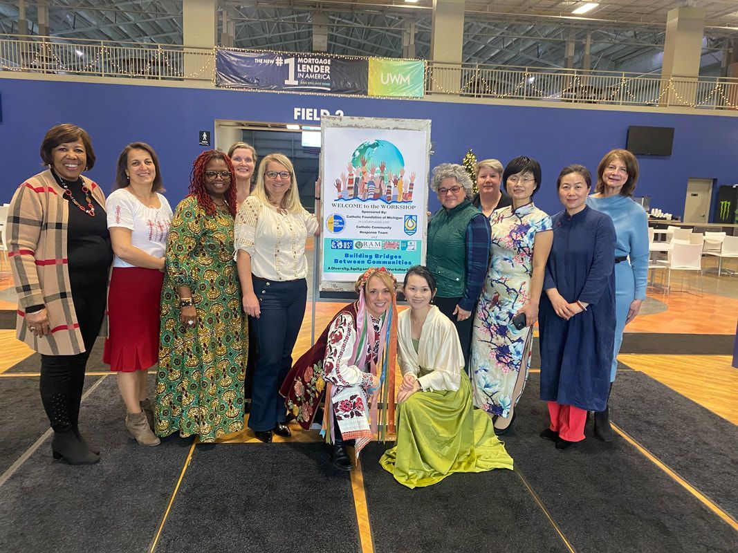 Group of women posing with a banner in a gym, various clothing styles.