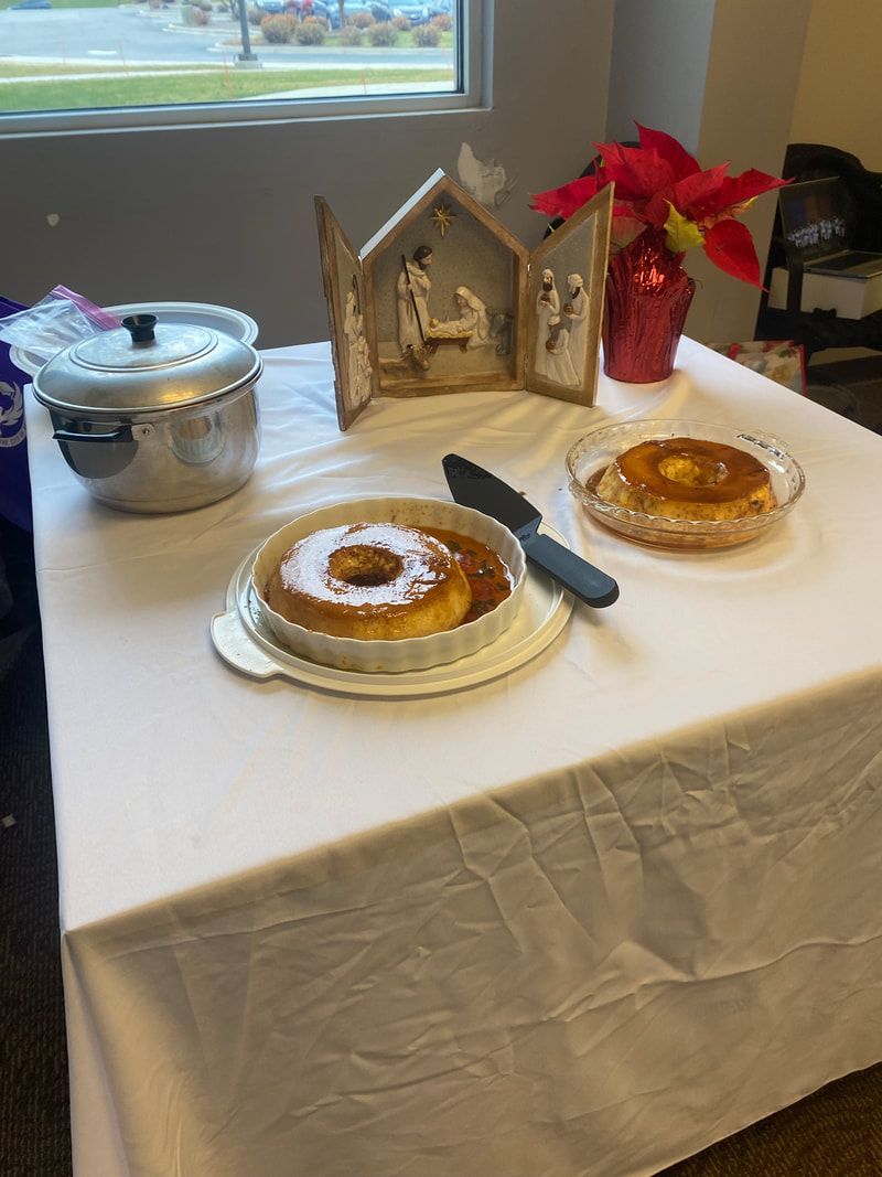 Table set with desserts and a nativity scene, possibly a Christmas gathering.