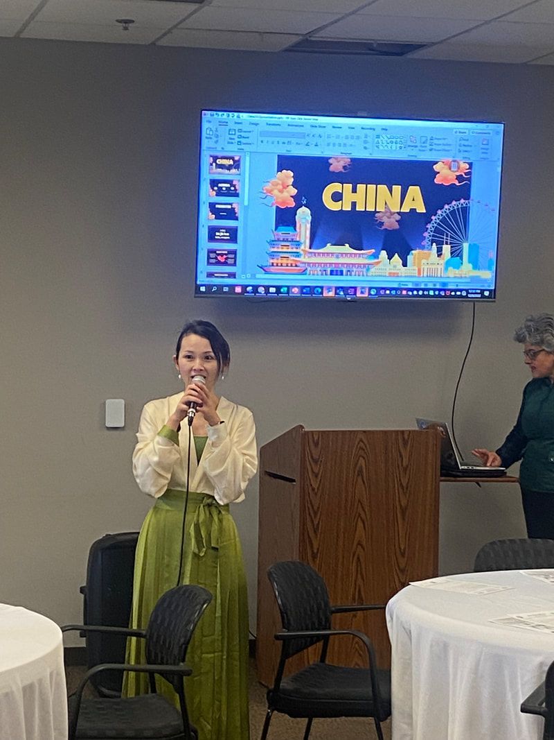 Woman in green outfit speaking at podium with 