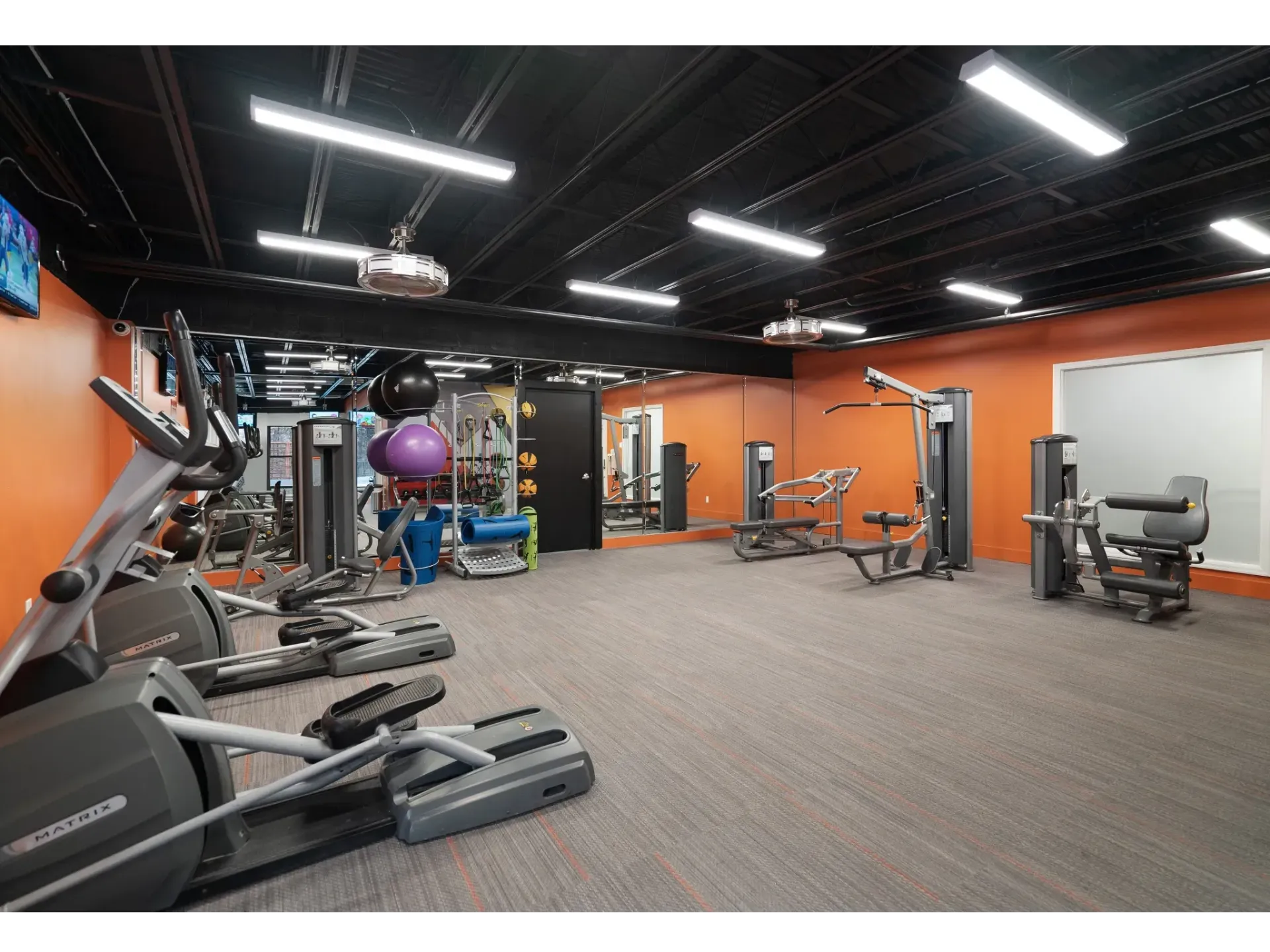 Well-equipped fitness center with cardio machines and weights at Haven on the Lake in Maryland Heights, MO.