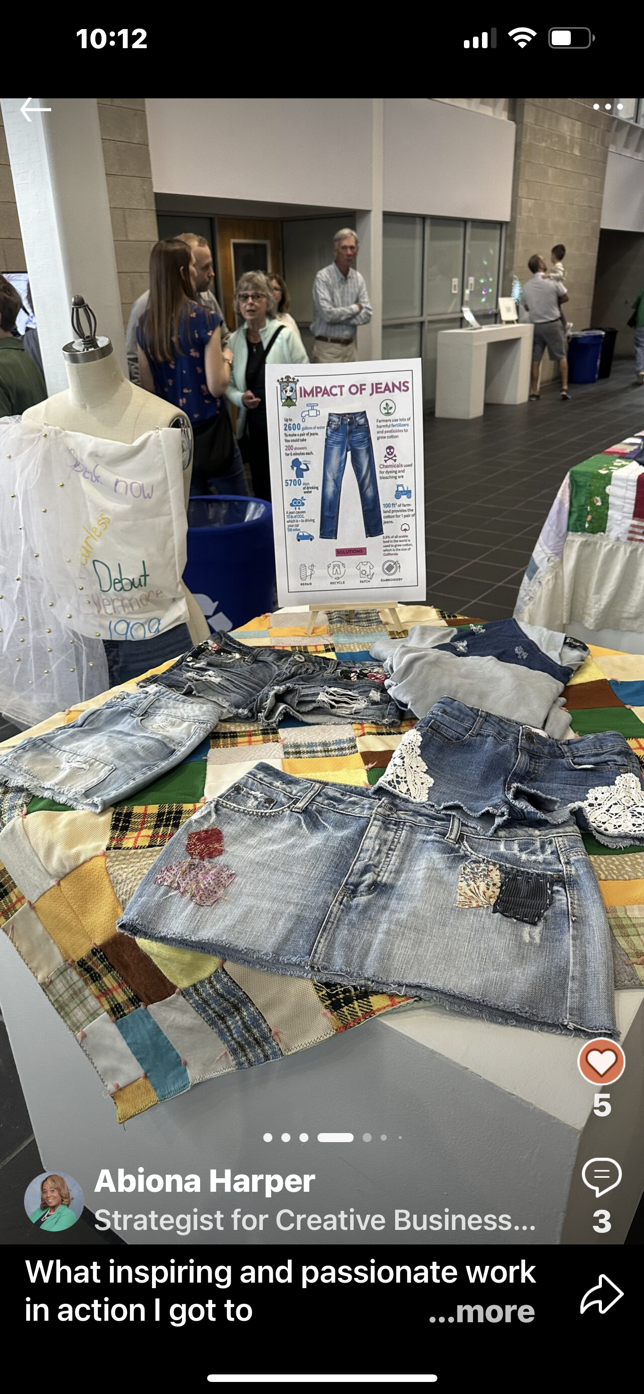 A table topped with a quilt and a pair of jeans.