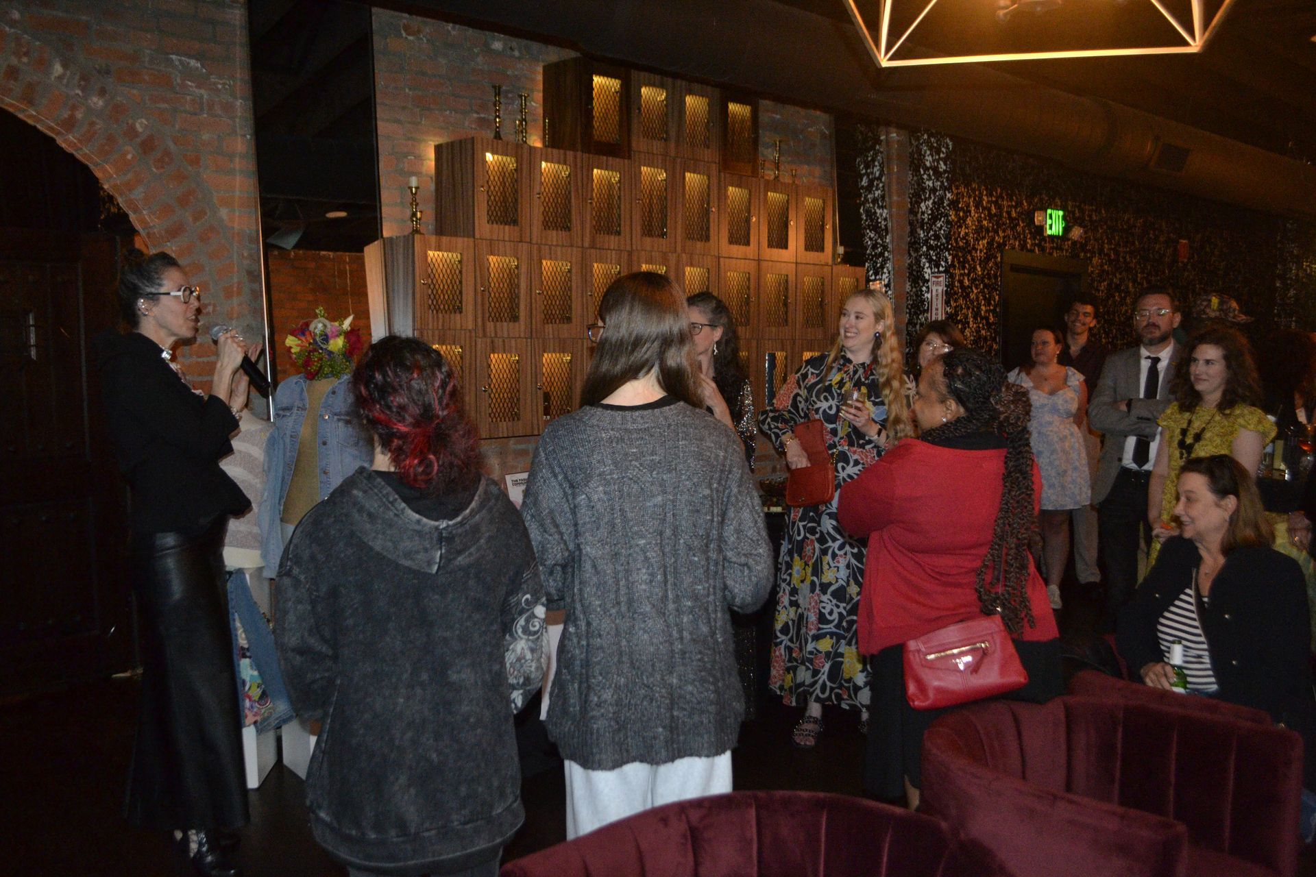 TFC Kickoff Party Priscila speaking crowd watching smiles