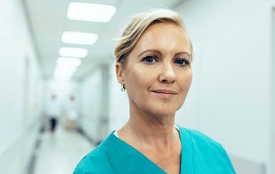 Nursing School — Female Nurse Standing in Hallway in Nashville, TN