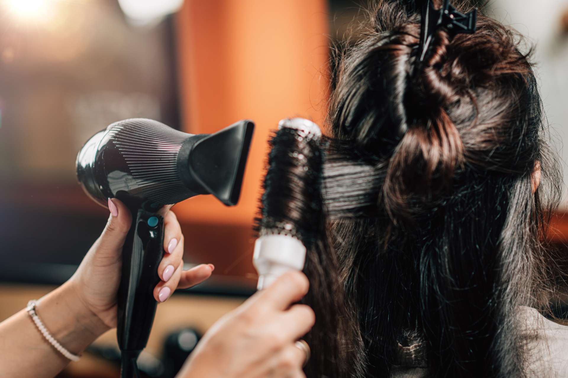 A young man is laying on a bed with his eyes closed.