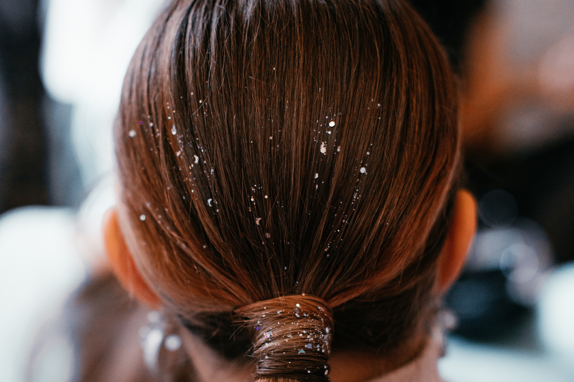 A young man is laying on a bed with his eyes closed.