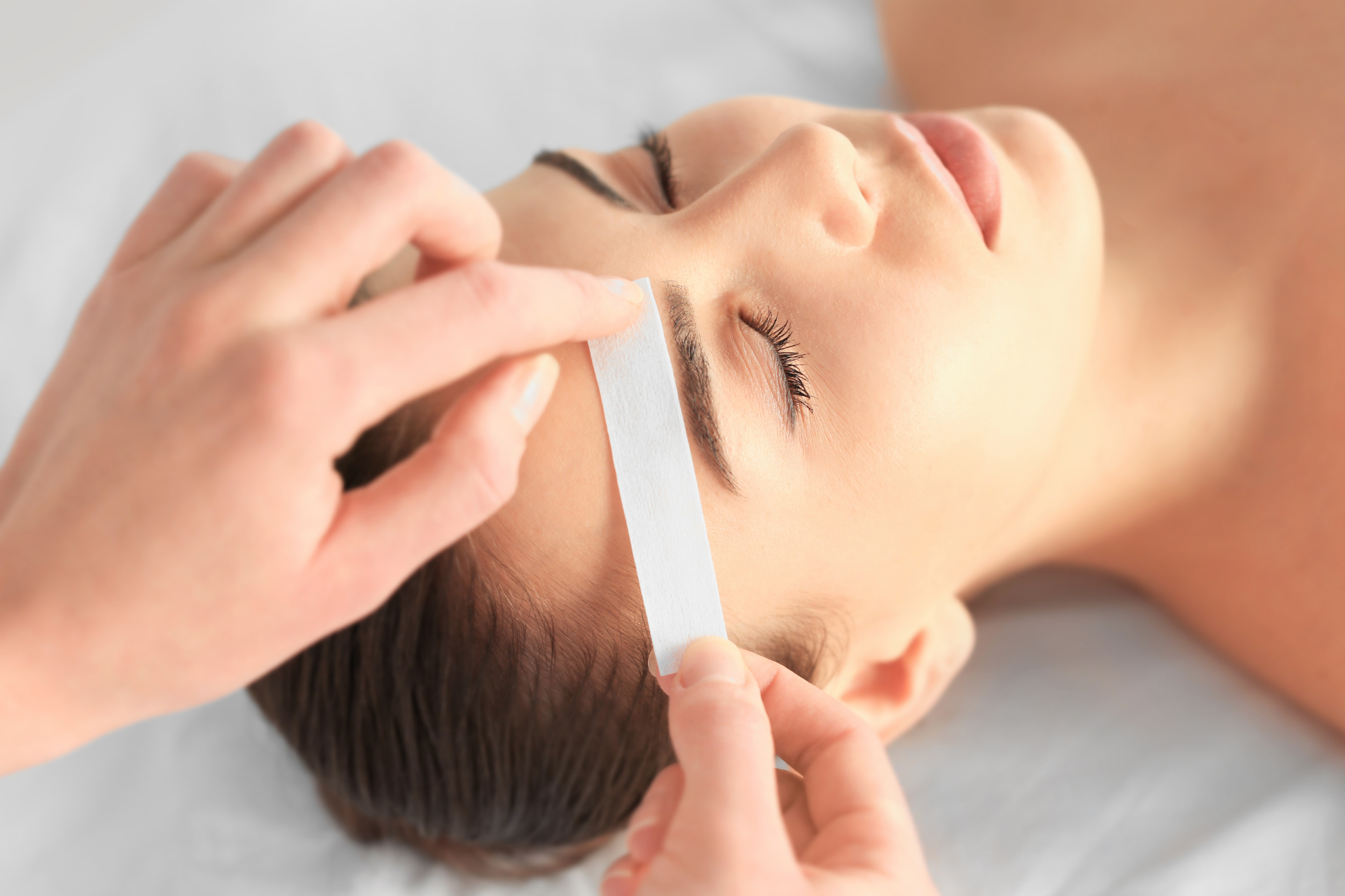 A woman is getting a facial treatment at a spa.