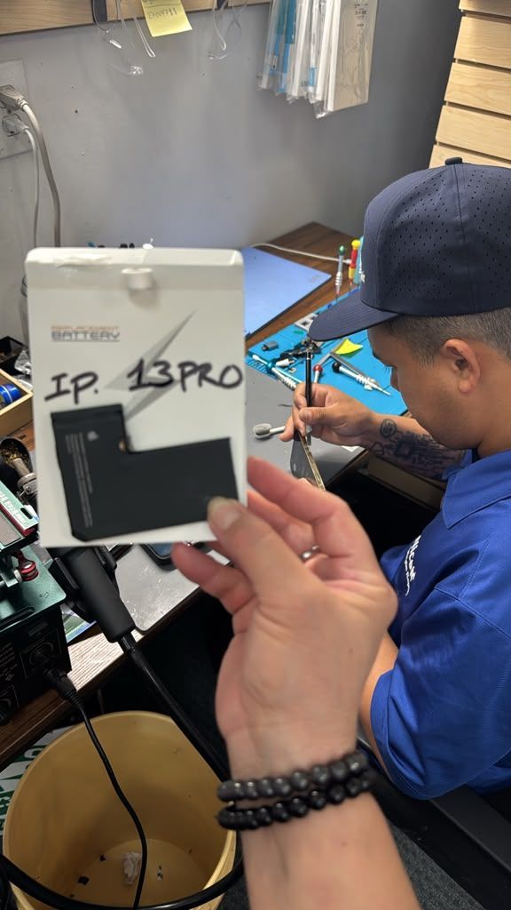 Technician repairing a game console at Nicell Cell Phone Repair in South Salt Lake Utah