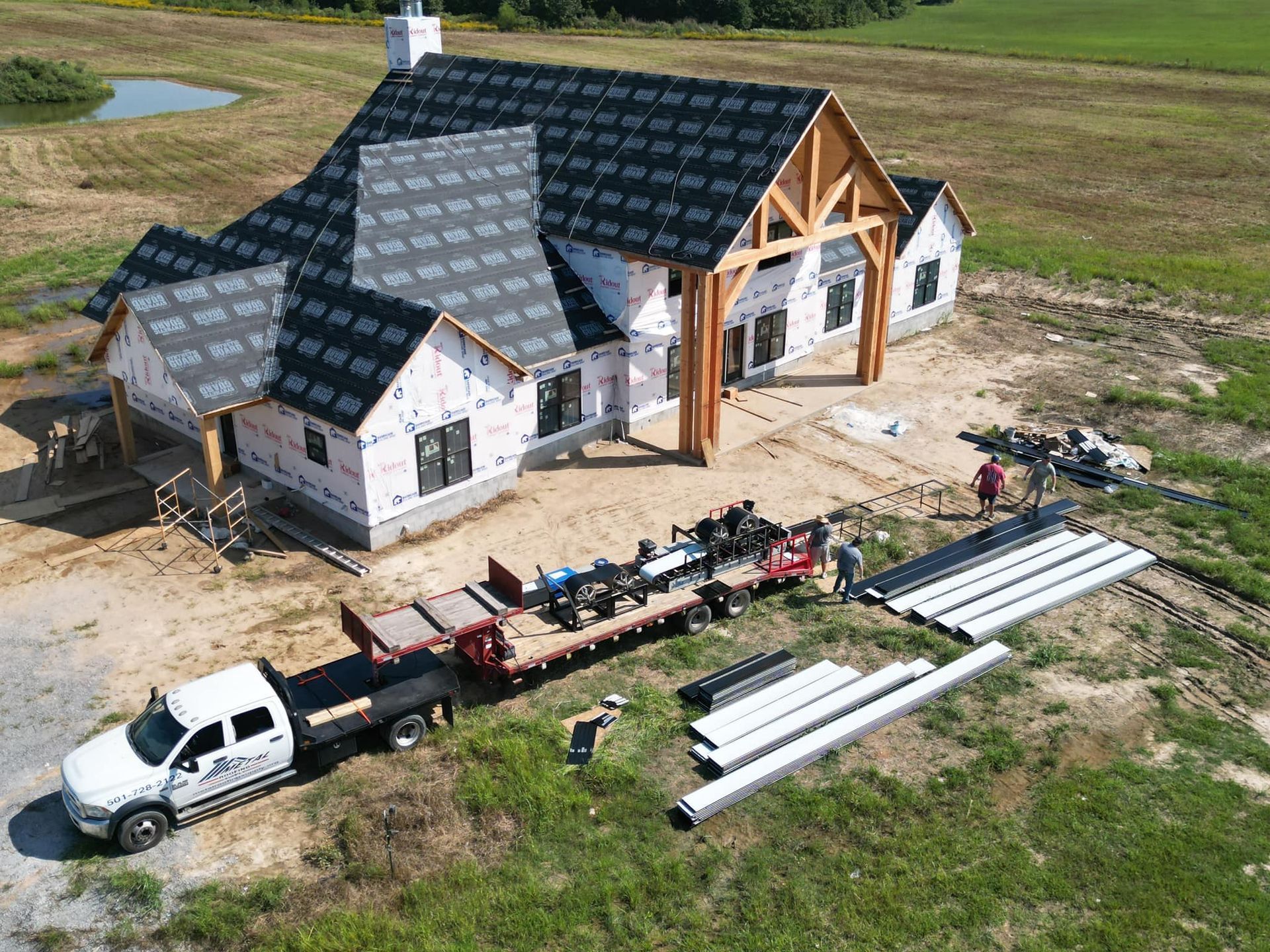 An aerial view of a house with a gray roof