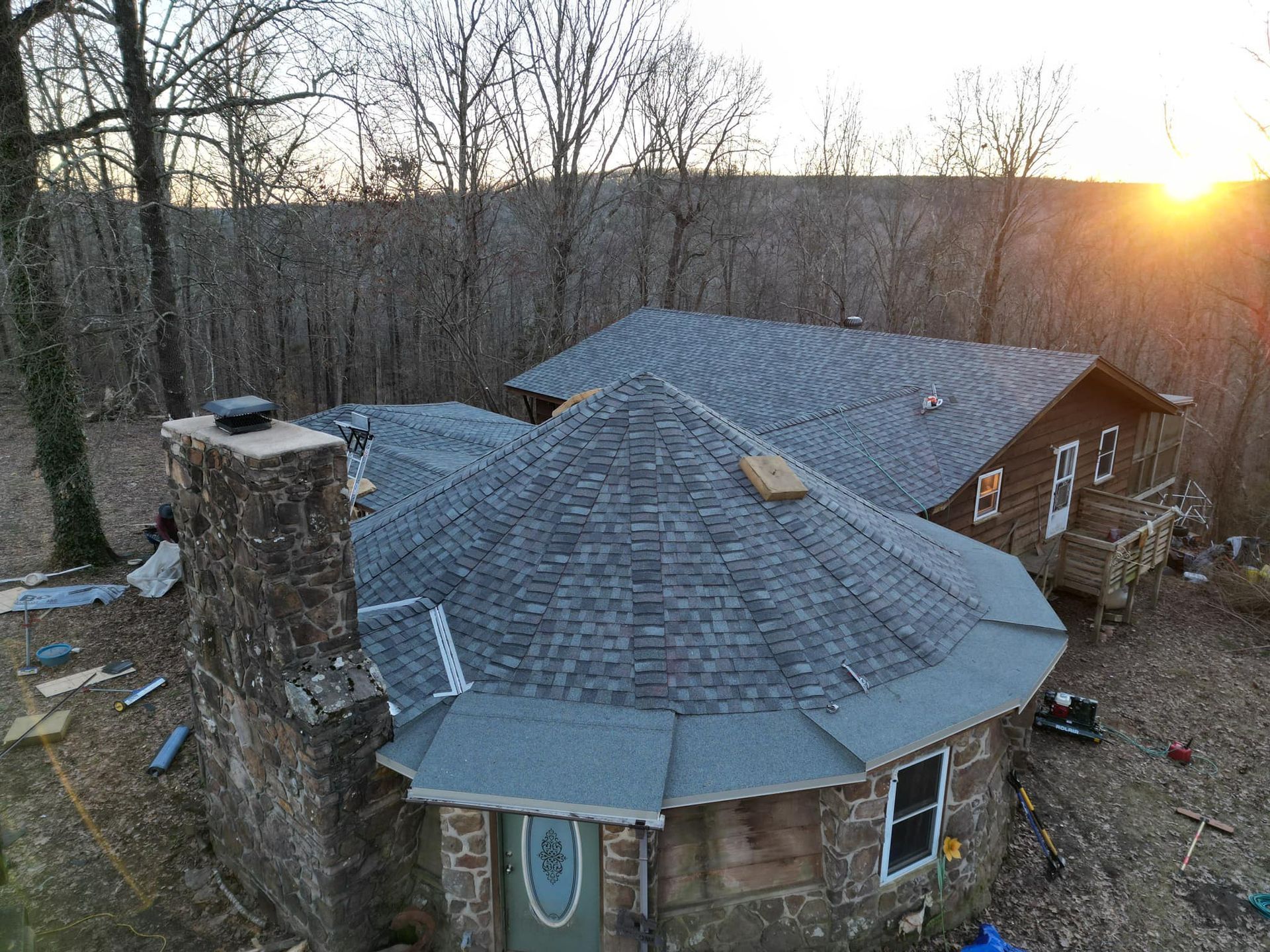 An aerial view of a house with a round roof and a chimney.