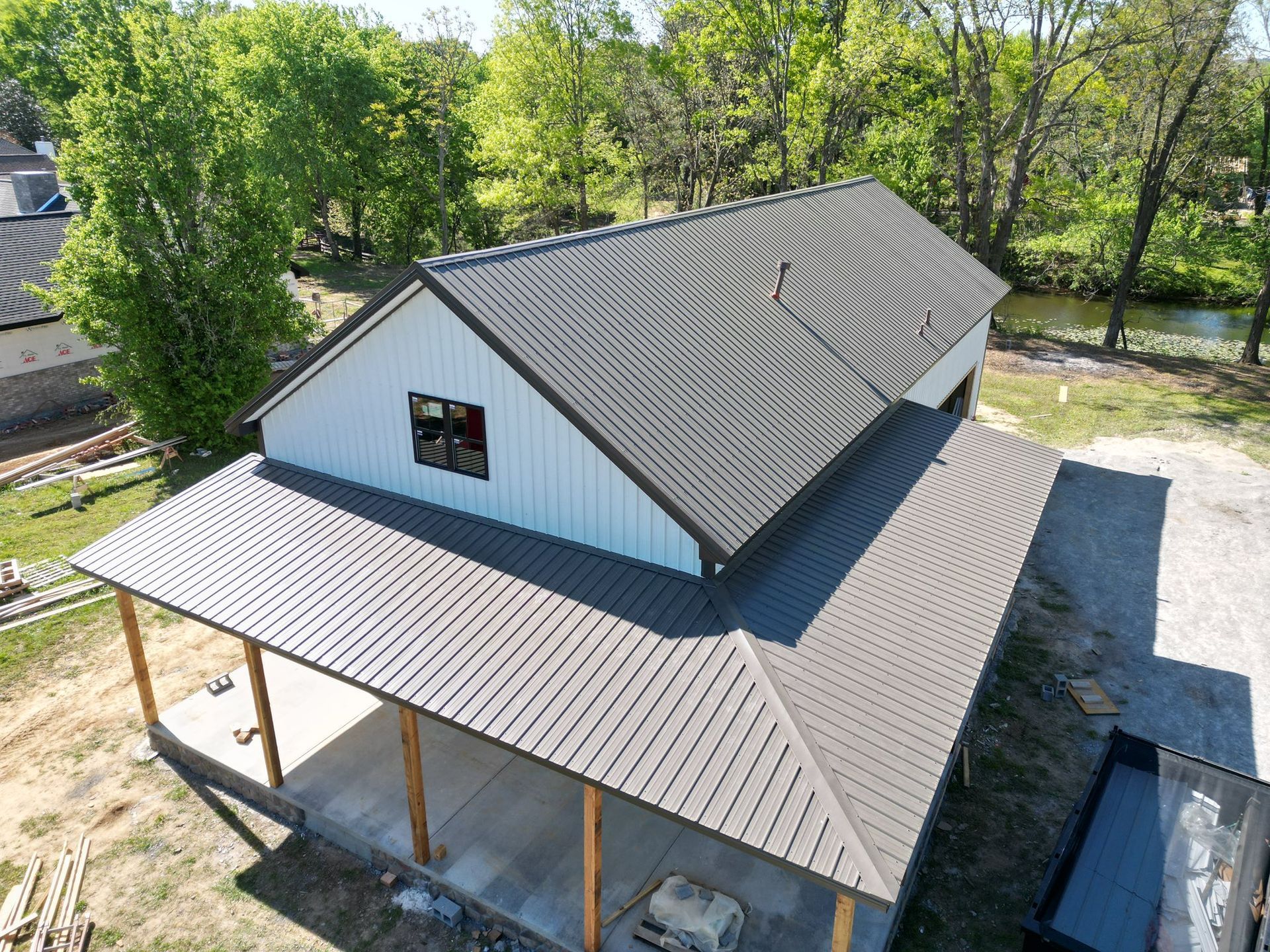 An aerial view of a house under construction with a metal roof.