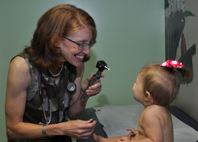 Doctor laughing when examining baby