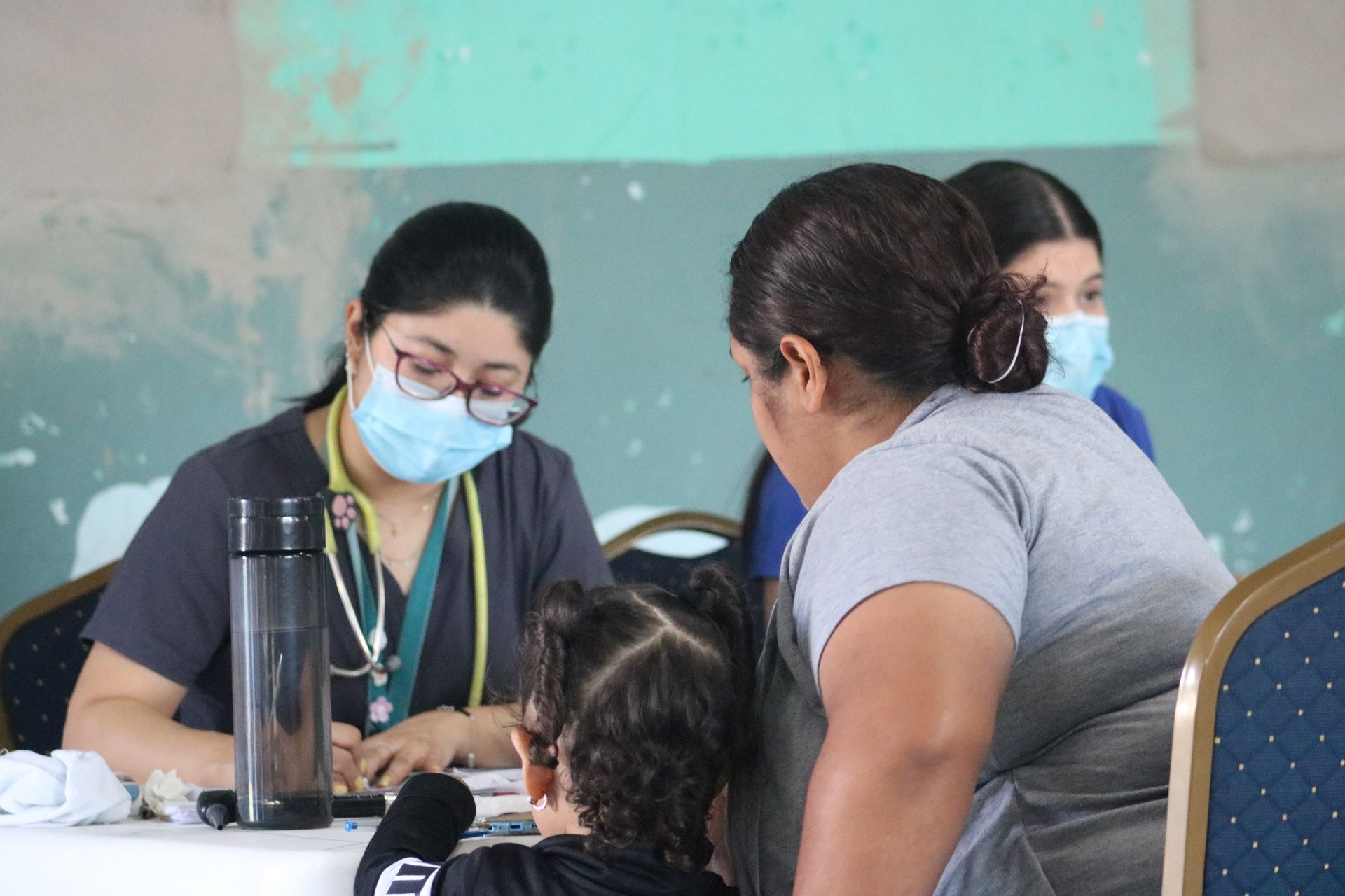 Mother and daughter receive free medical consultation during an ASJ campaign to identify and report child sexual abuse.