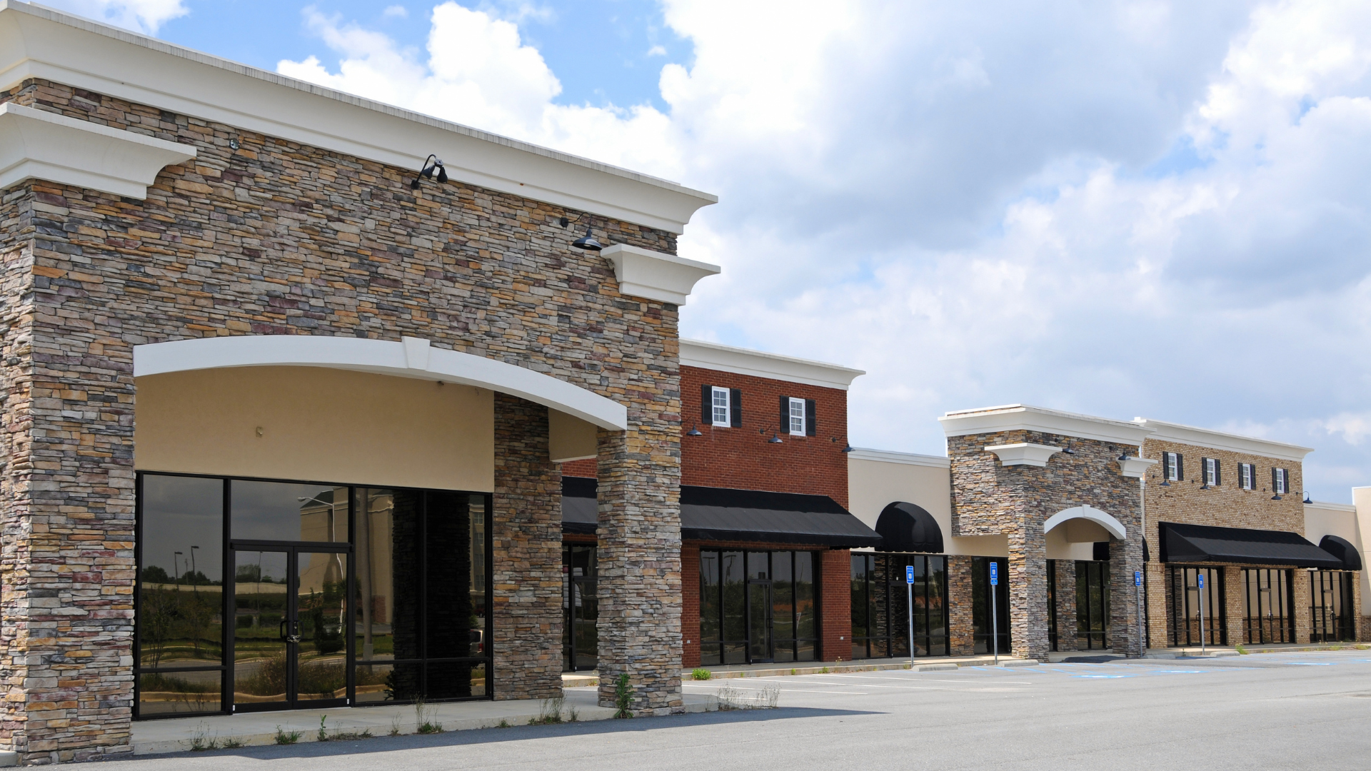 A row of brick buildings with a lot of windows and awnings