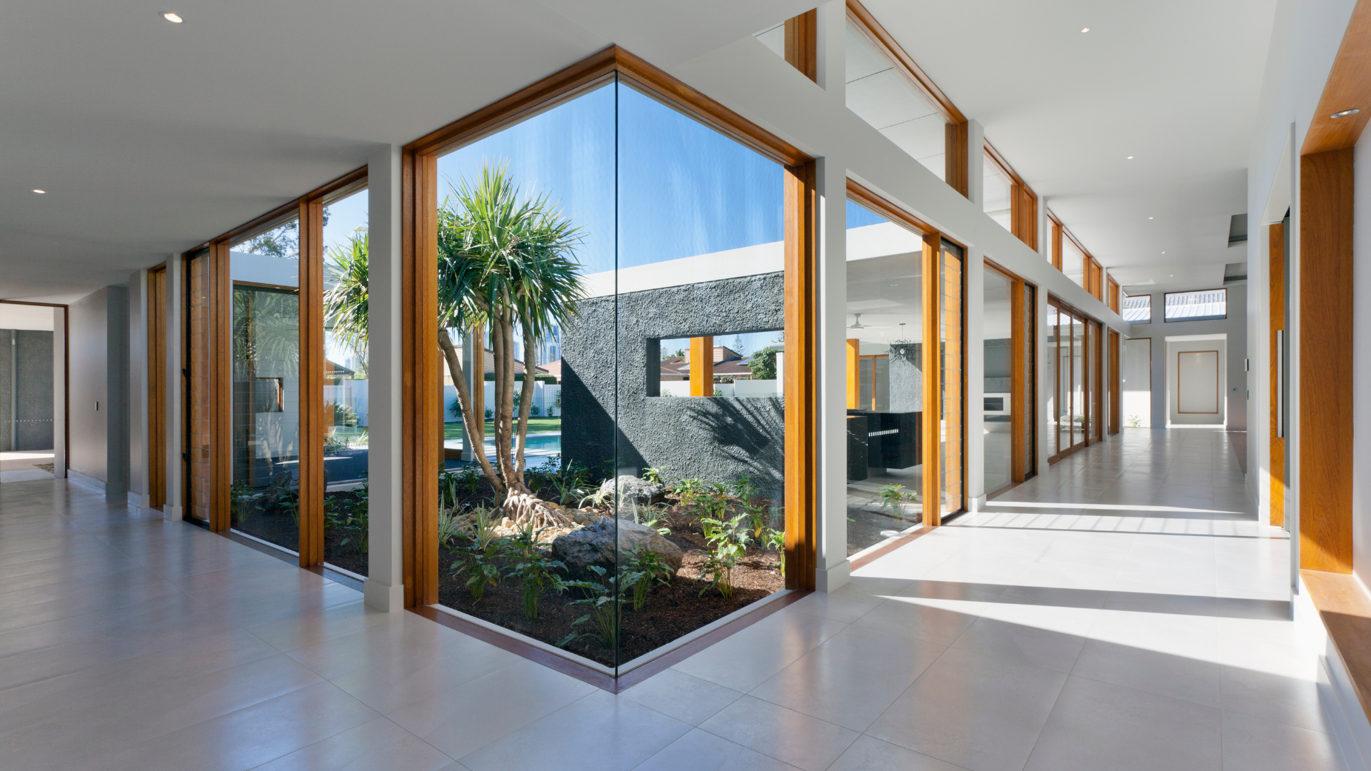 A hallway in a house with a lot of windows