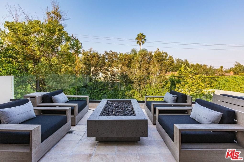 There is a fire pit in the middle of the patio.