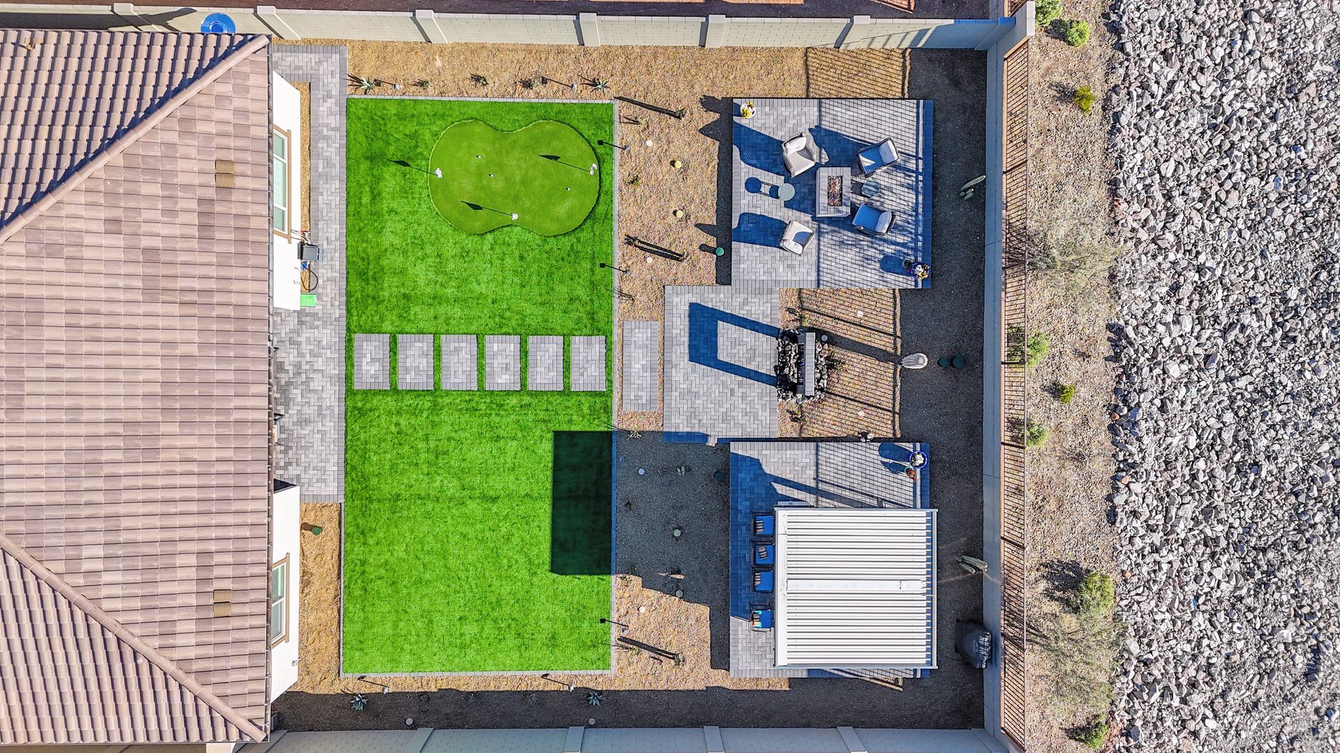 An aerial view of a backyard with a playground and a house.